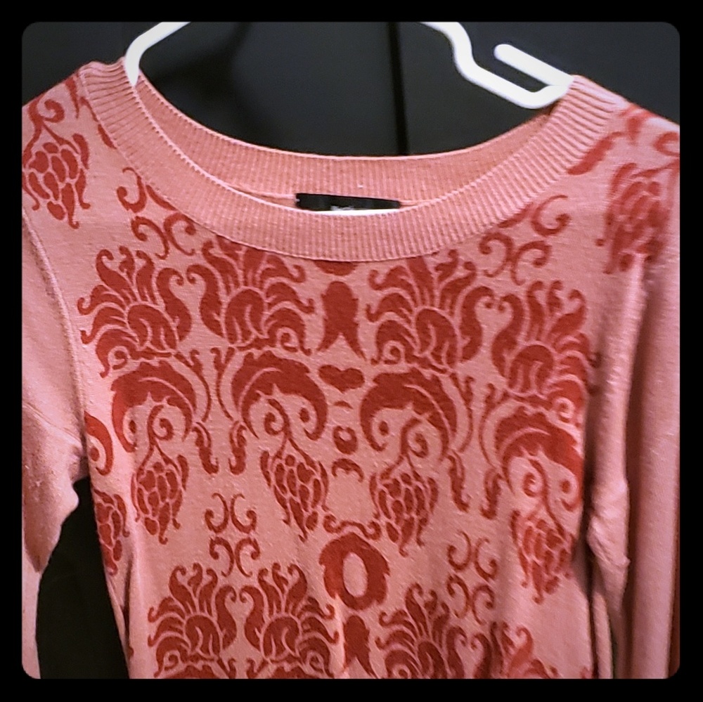 Pink sweater with red design